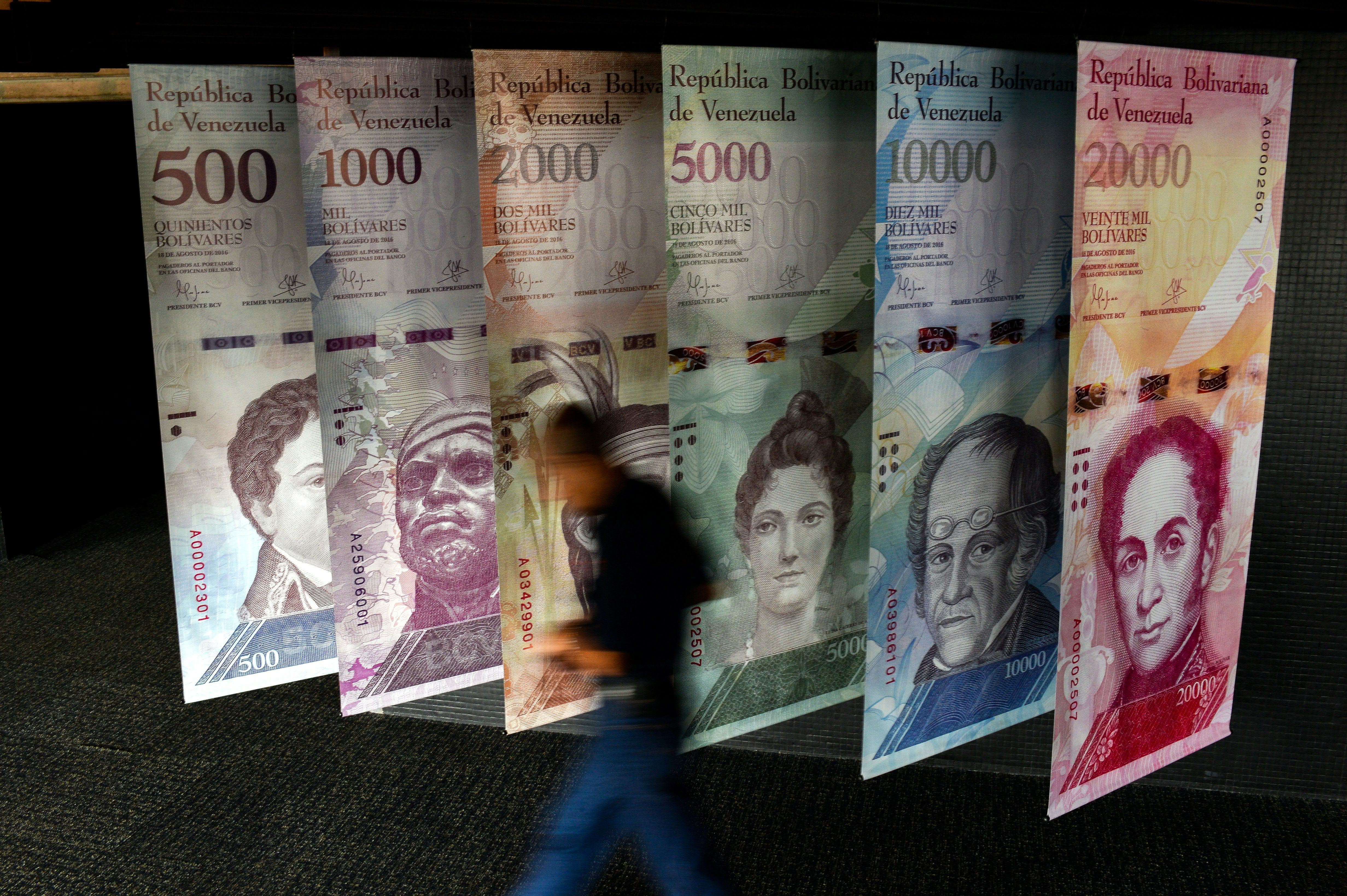 A banner depicting Venezuela's currency, the bolivar, at ...