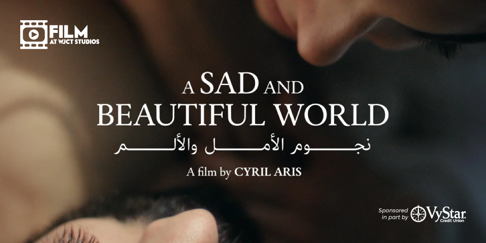 A cinematic title card with a dark, warm-toned close-up of partially visible faces in the background. Centered white text reads “A SAD AND BEAUTIFUL WORLD,” with Arabic text beneath it. Below the title is the credit “A film by CYRIL ARIS.” The upper-left corner contains the FILM AT WJCT STUDIOS logo, and the lower-right corner contains a sponsorship notice for VyStar Credit Union.
